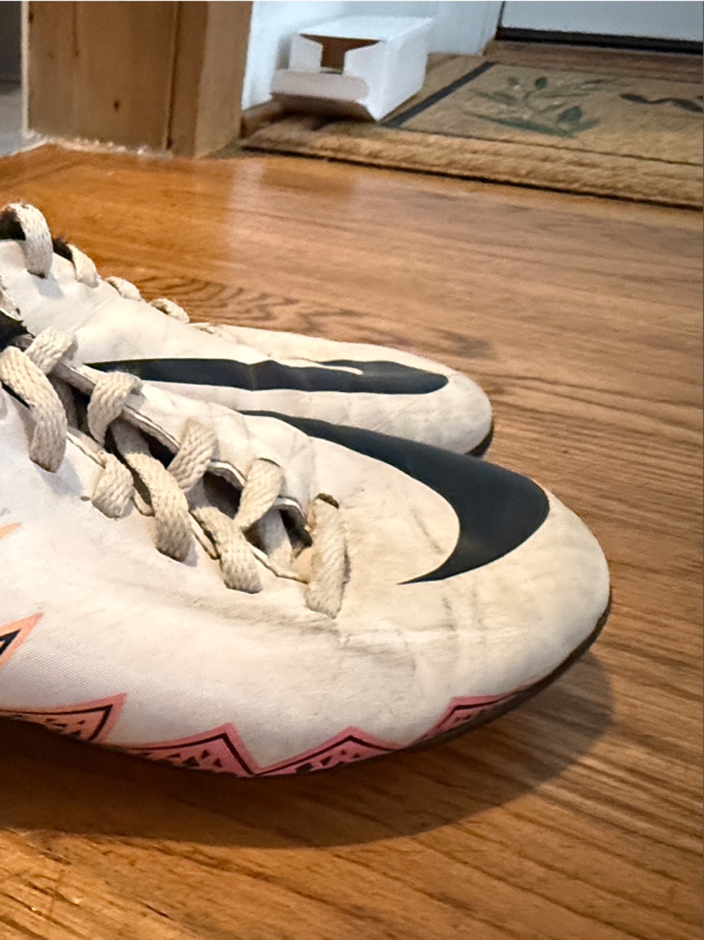 Nike Kids White Soccer Cleats with Black Swoosh and Pink/Yellow Accents